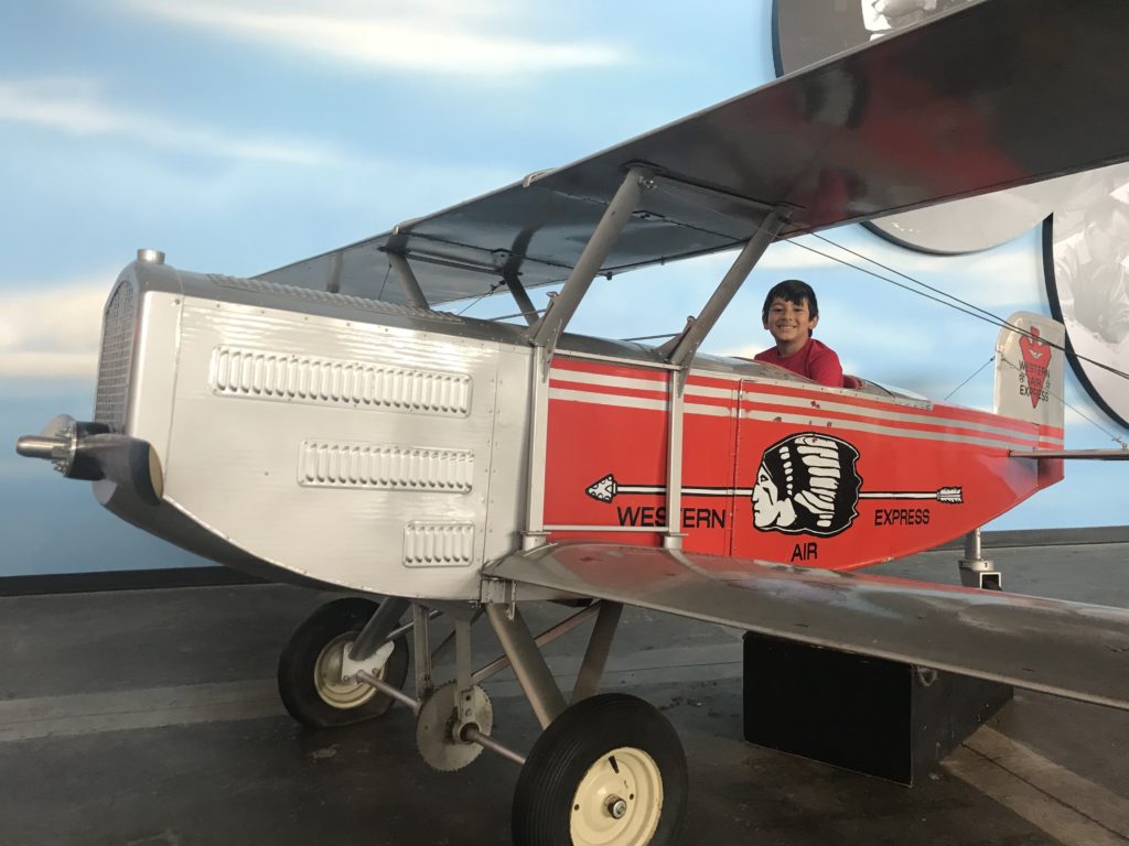 a boy sitting in a small plane