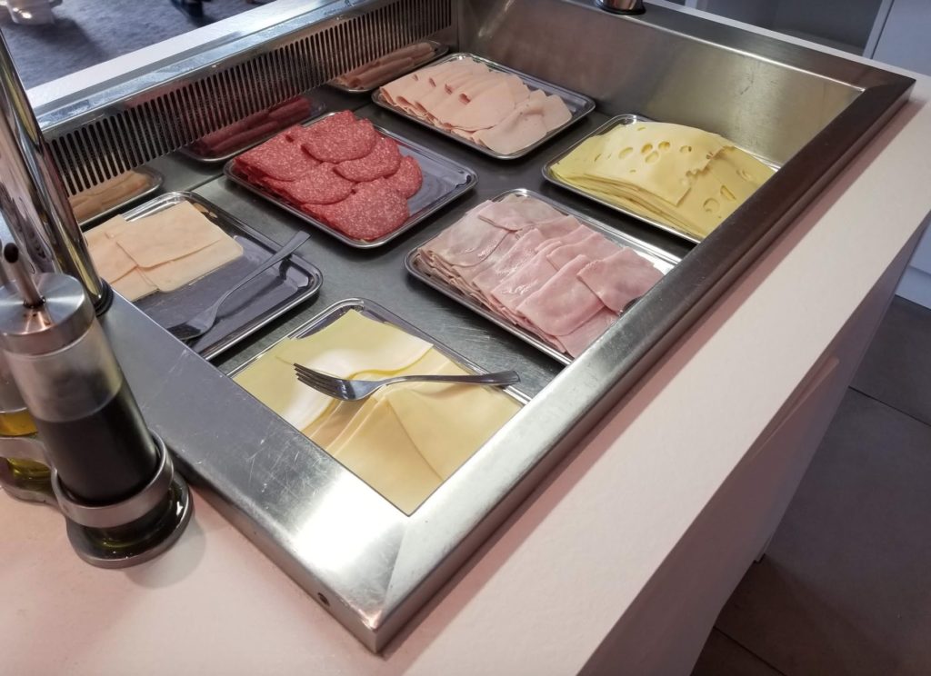 trays of meat and cheese on a counter