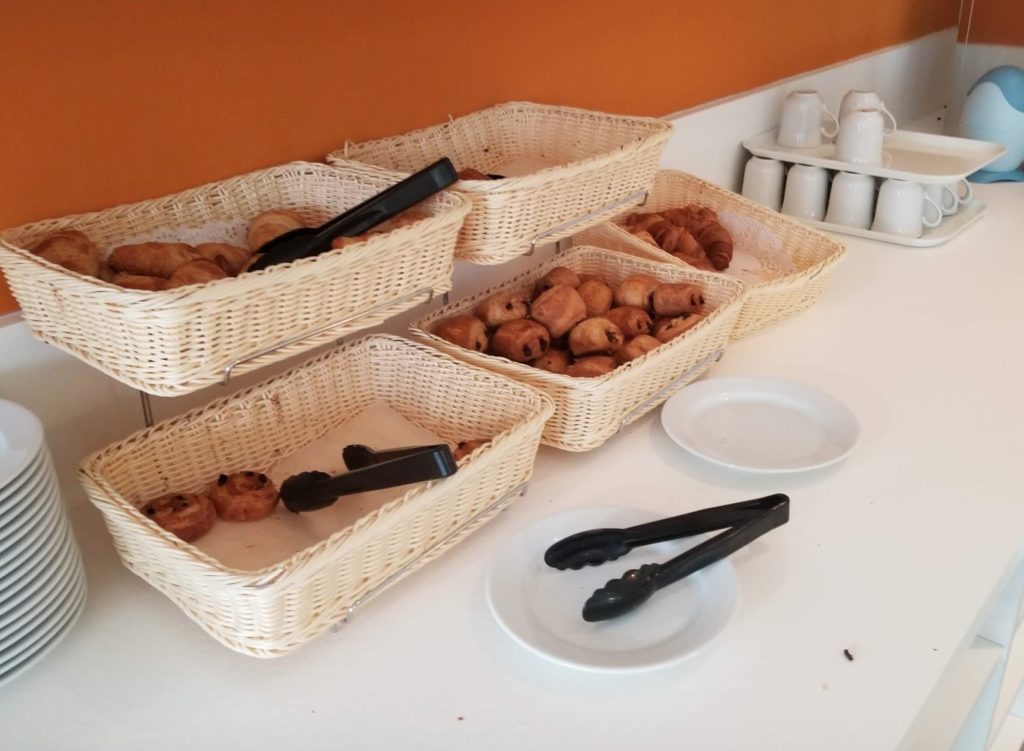 baskets of pastries and tongs on a counter