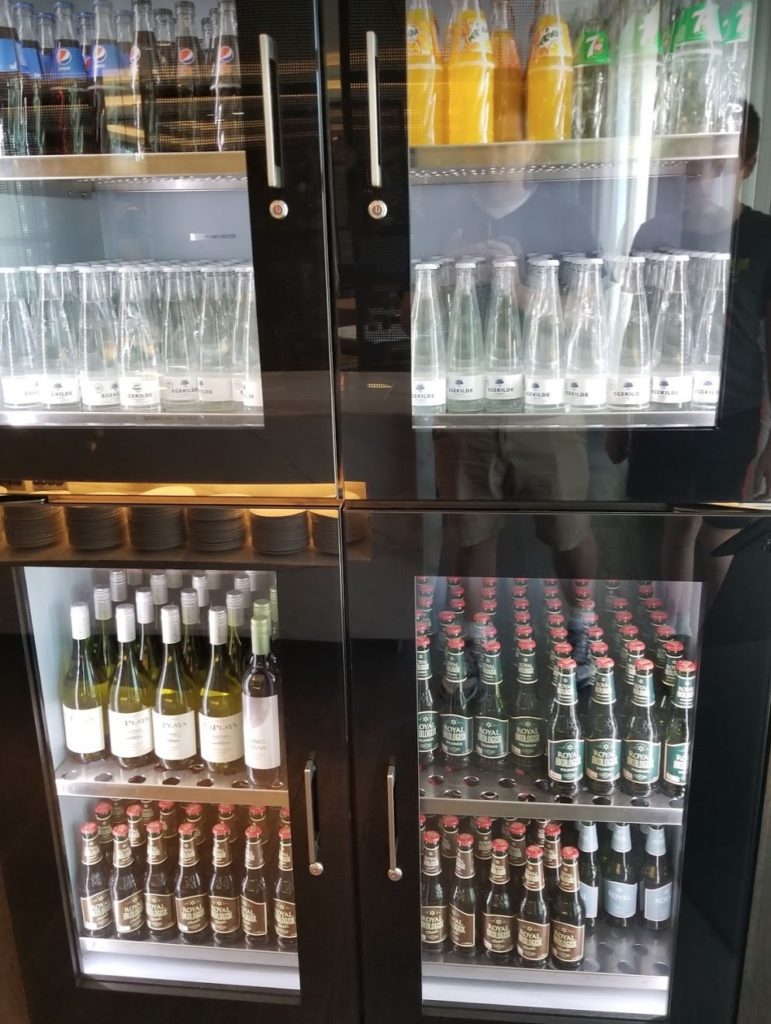 a glass cabinet with bottles and glasses