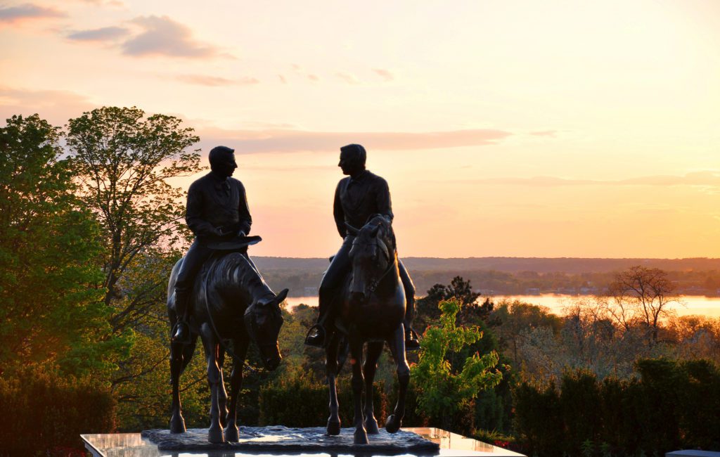 a statue of two men on horses