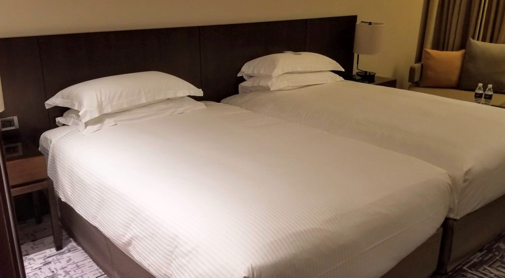 two beds with white sheets