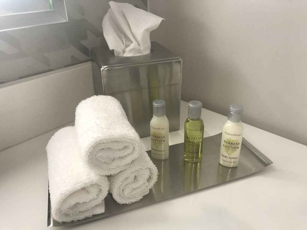 a tray with towels and toiletries on it