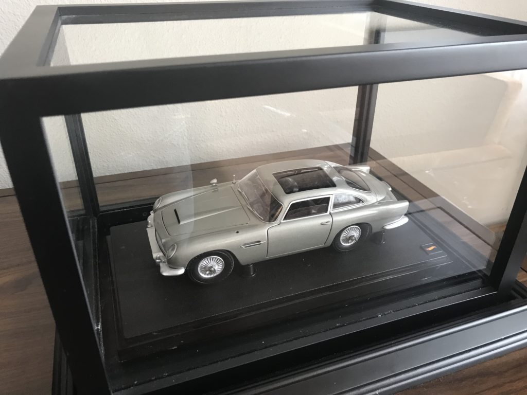 a silver car in a glass case