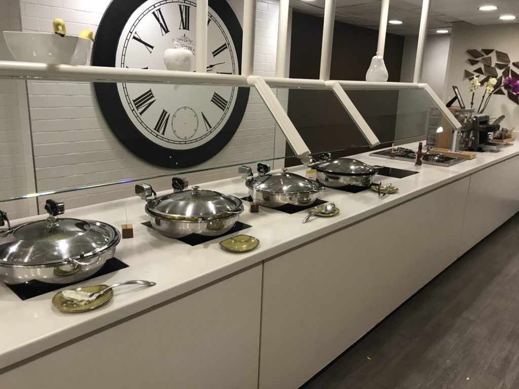 a kitchen with pans and pans on top of a counter