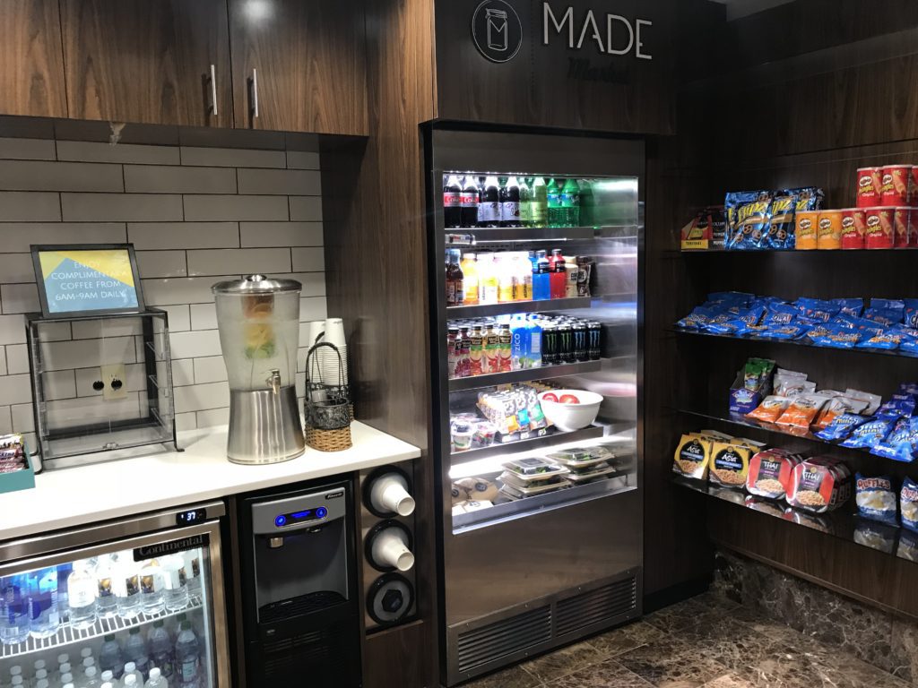 a refrigerator with drinks and snacks on shelves