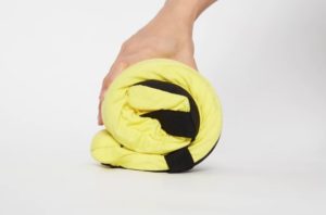 a hand holding a yellow blanket