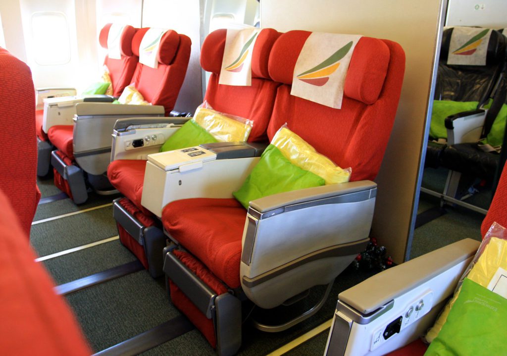 a row of red seats with pillows