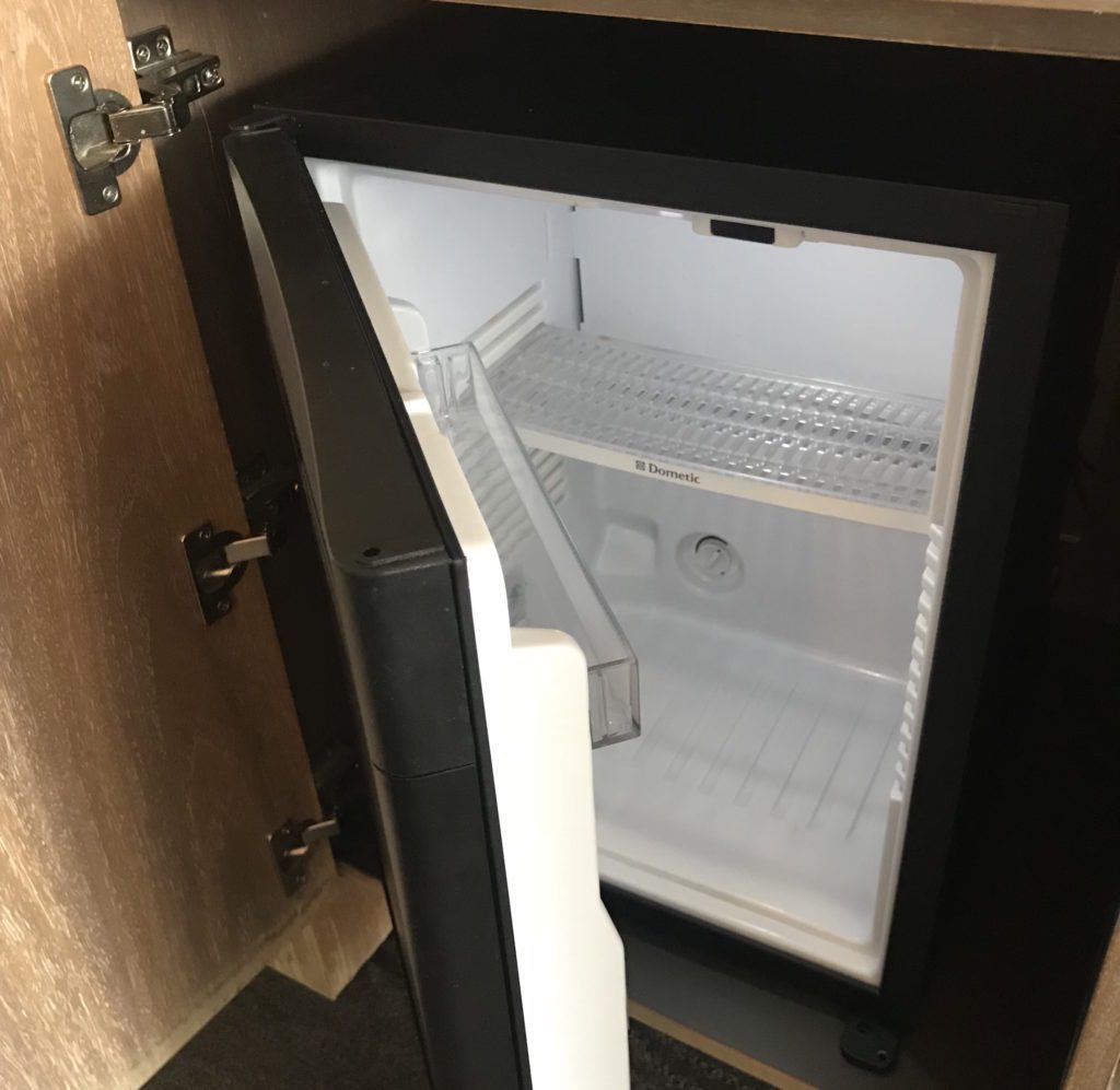 a small black and white refrigerator
