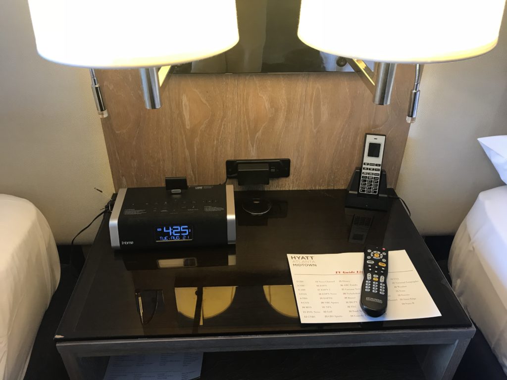 a table with a clock and remote control