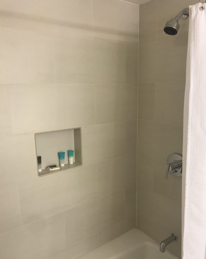 a shower with a shower head and shower head