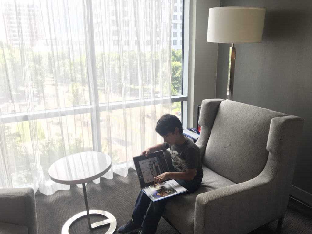 a boy sitting on a chair with a book