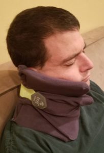 a man with a neck pillow