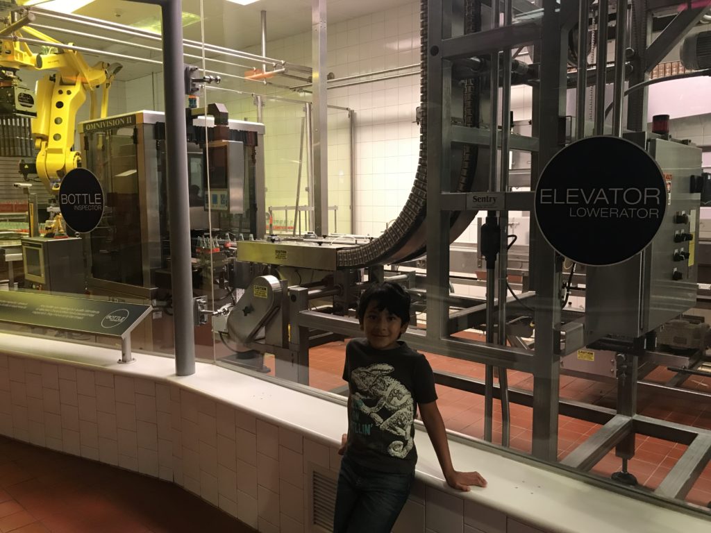 a boy standing in front of a machine