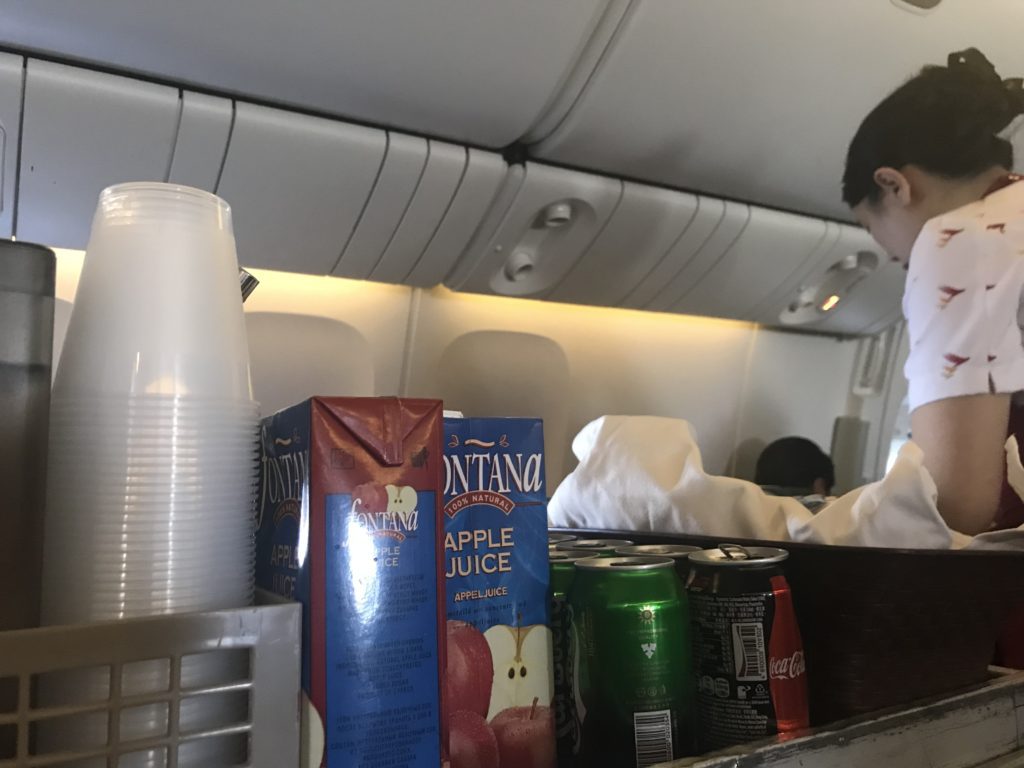 a group of drinks and beverages on an airplane