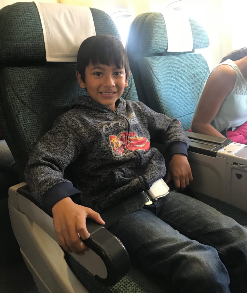 a boy sitting in an airplane seat
