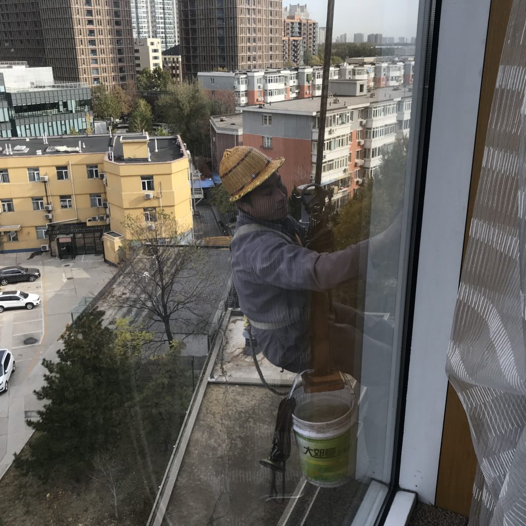 a man climbing a window