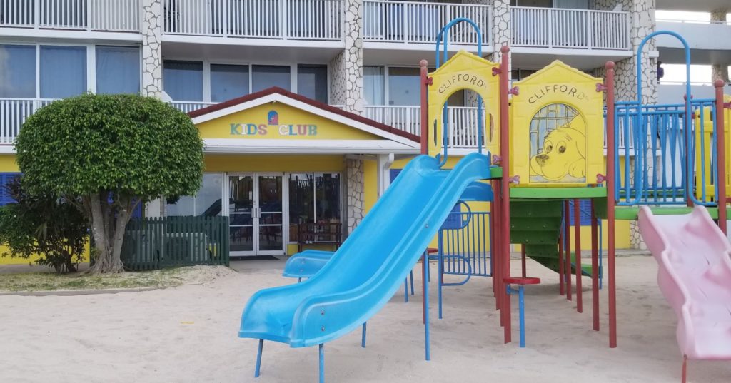 a playground with a slide in front of a building