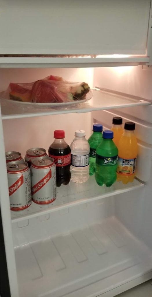 a refrigerator full of soda and food