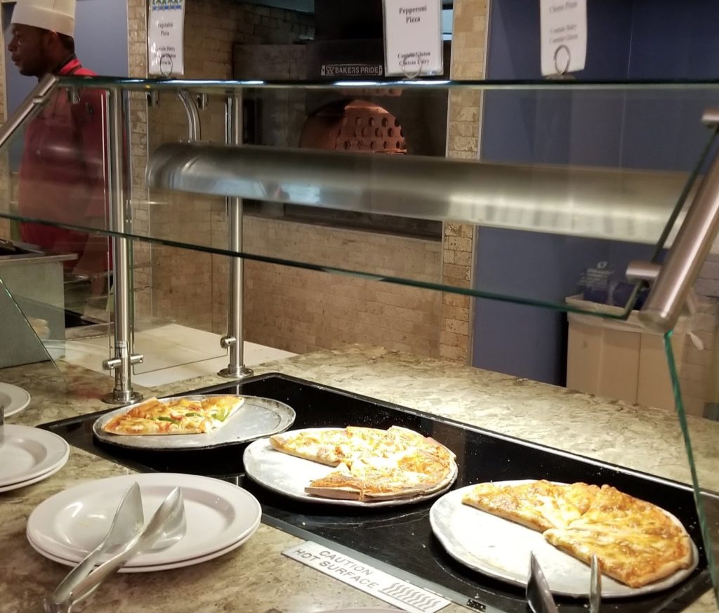 a pizza on plates on a counter