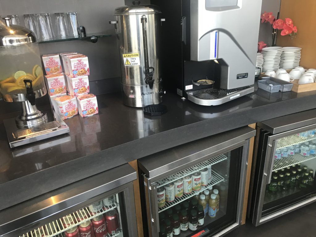 a coffee machine and drinks on a counter