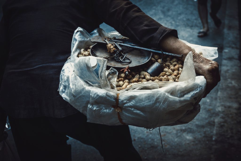 a person holding a bag of peanuts