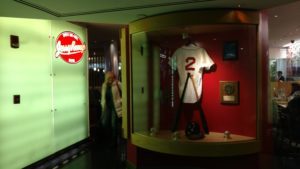 a display case with a baseball jersey and a helmet