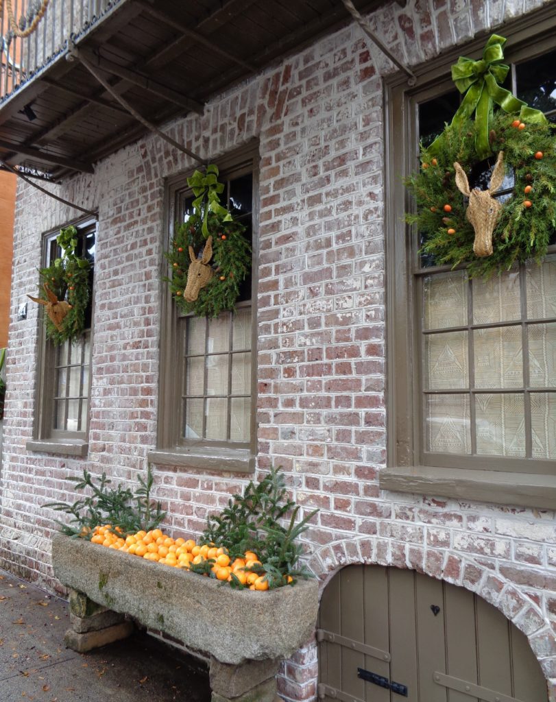 a brick building with wreaths and oranges
