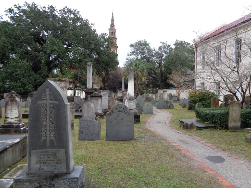 a cemetery with a path and a building