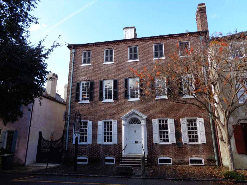 a brick building with white doors and windows with Heyward-Washington House in the background