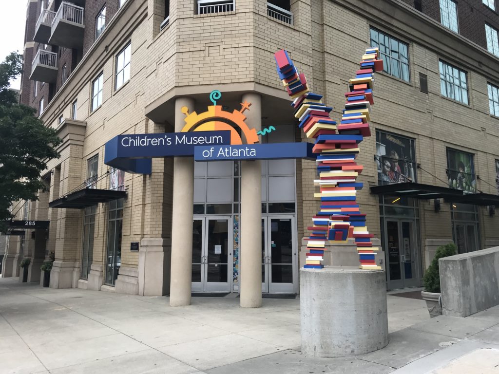a statue of a book sculpture in front of a building