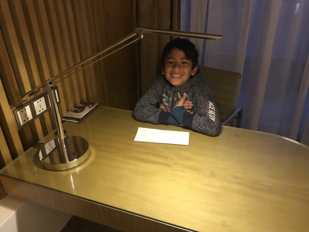 a boy sitting at a desk