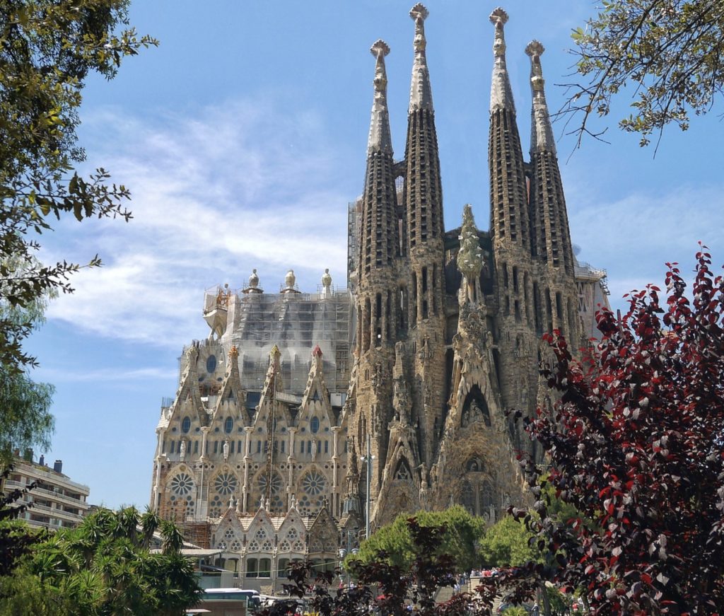 a large building with towers with Sagrada Família in the background
