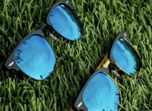 a pair of sunglasses lying on grass
