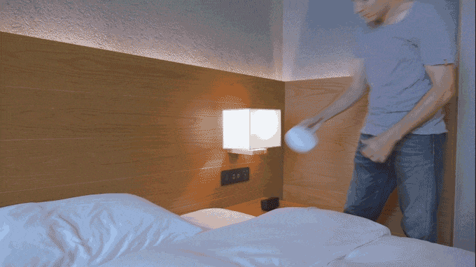 a man throwing a ball in a bed