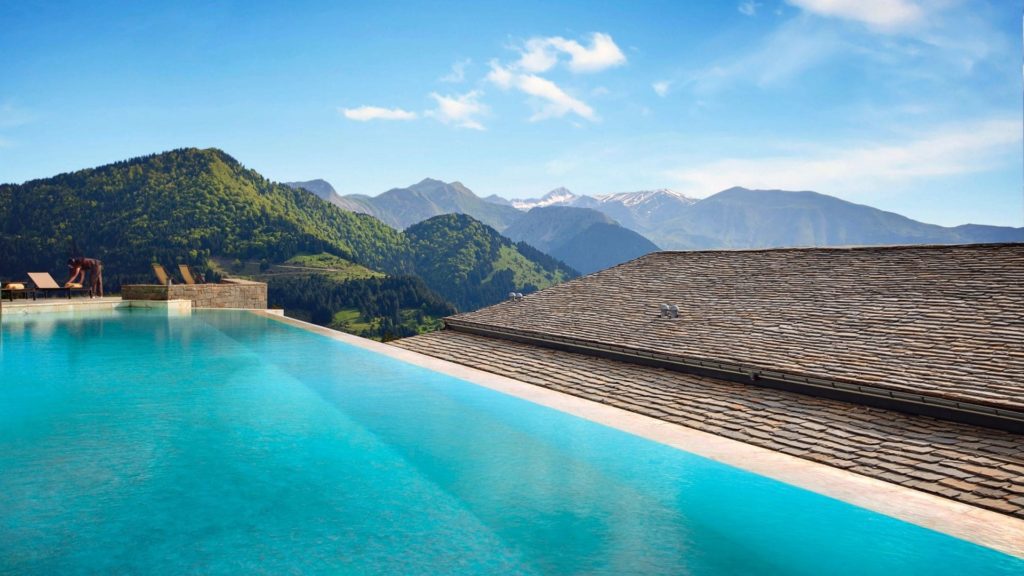 a pool on a roof overlooking mountains