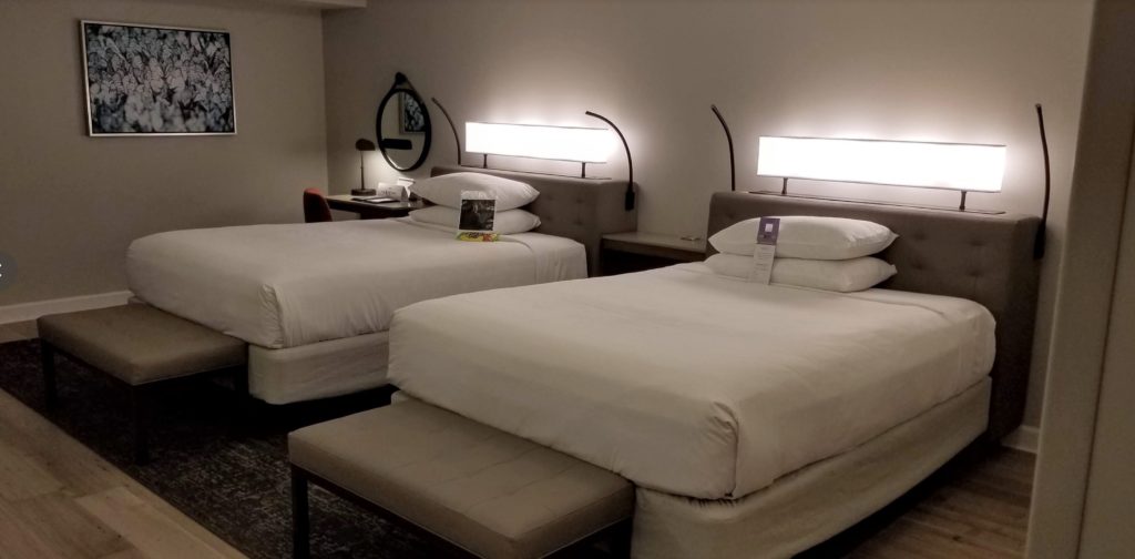 two beds with lights on them