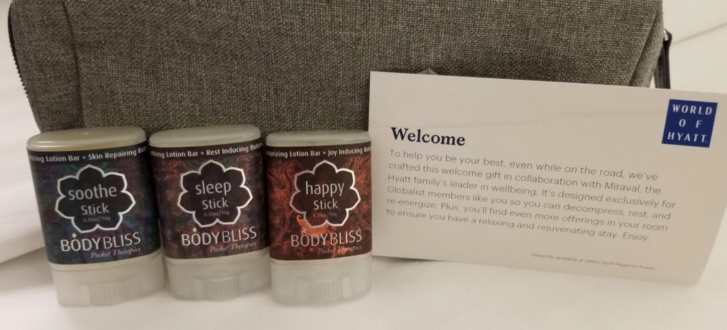 a group of small bottles next to a welcome card