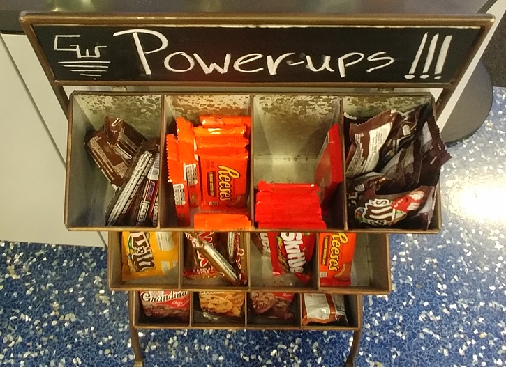 a candy bar shelf with a sign