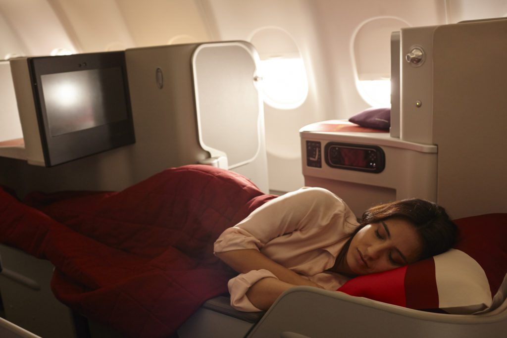 a woman sleeping on a plane