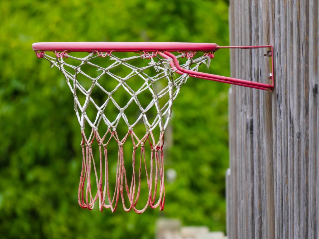 a basketball hoop with net attached to a wood wall