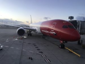 a red and white airplane on a tarmac