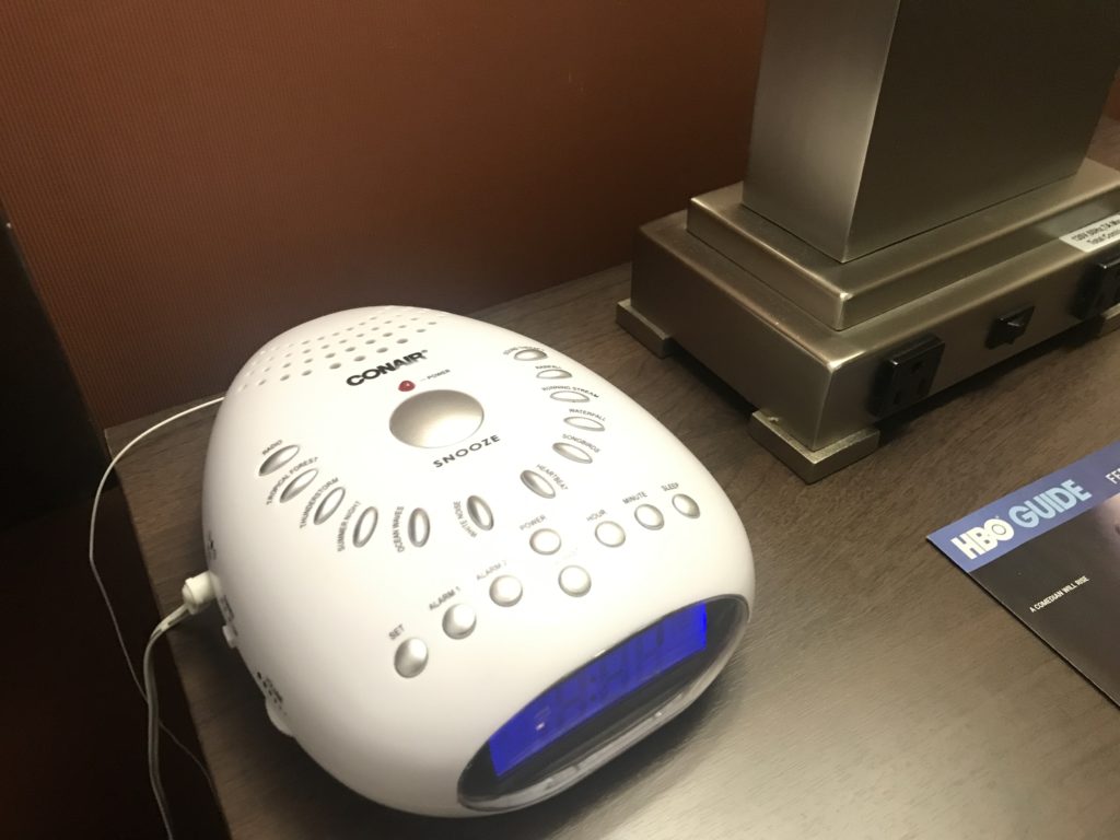 a white alarm clock on a table