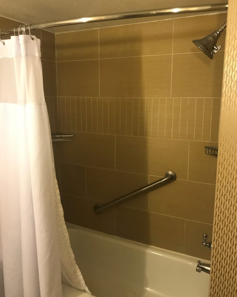 a shower curtain and tub in a bathroom