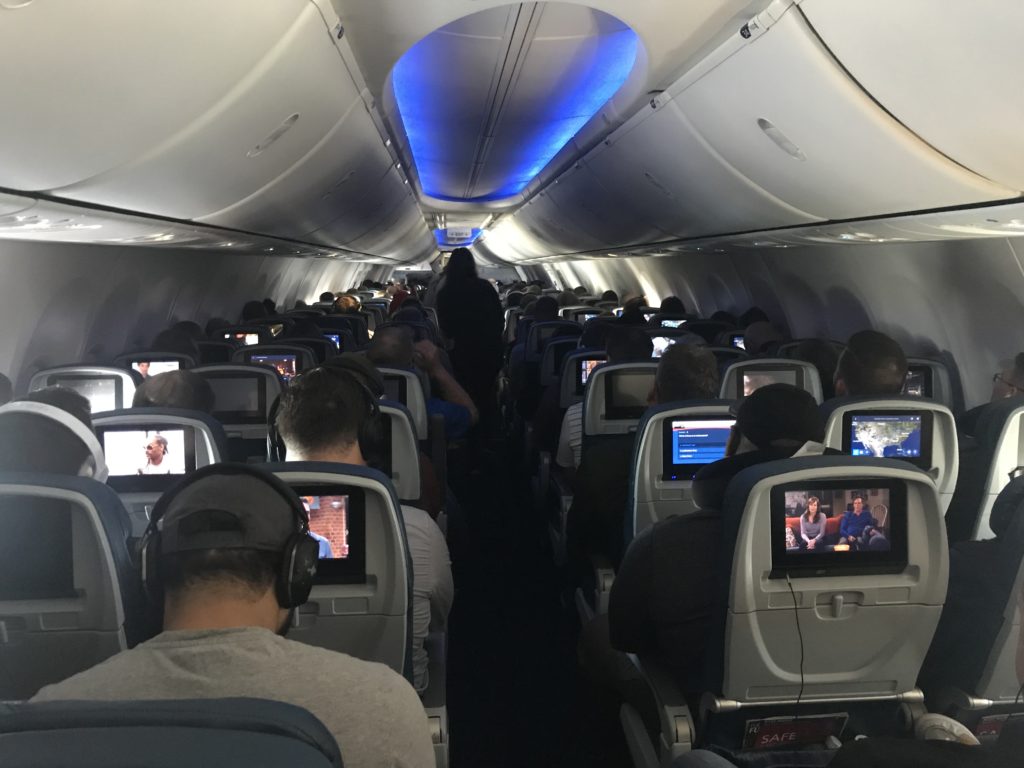 a group of people sitting in an airplane