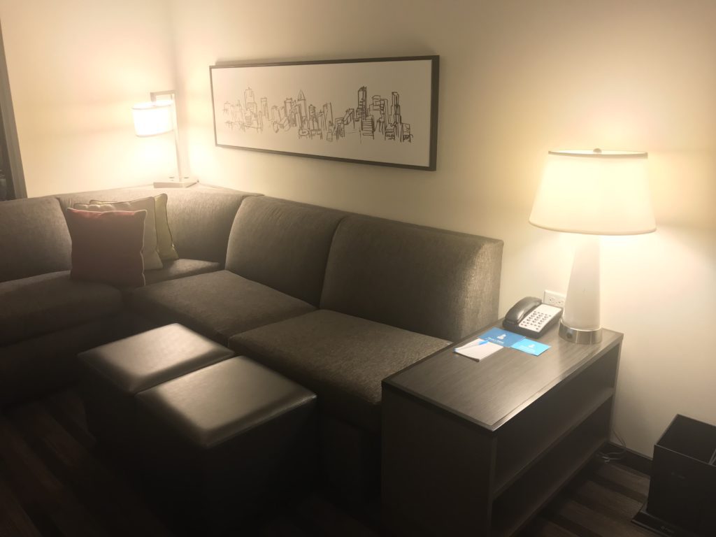 a couch with a lamp and a table