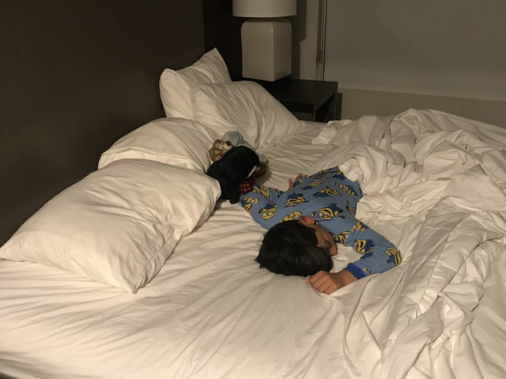a boy sleeping on a bed