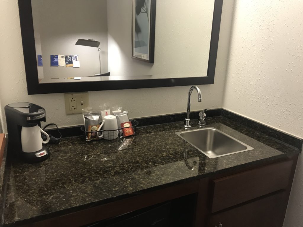 a sink and mirror in a hotel room