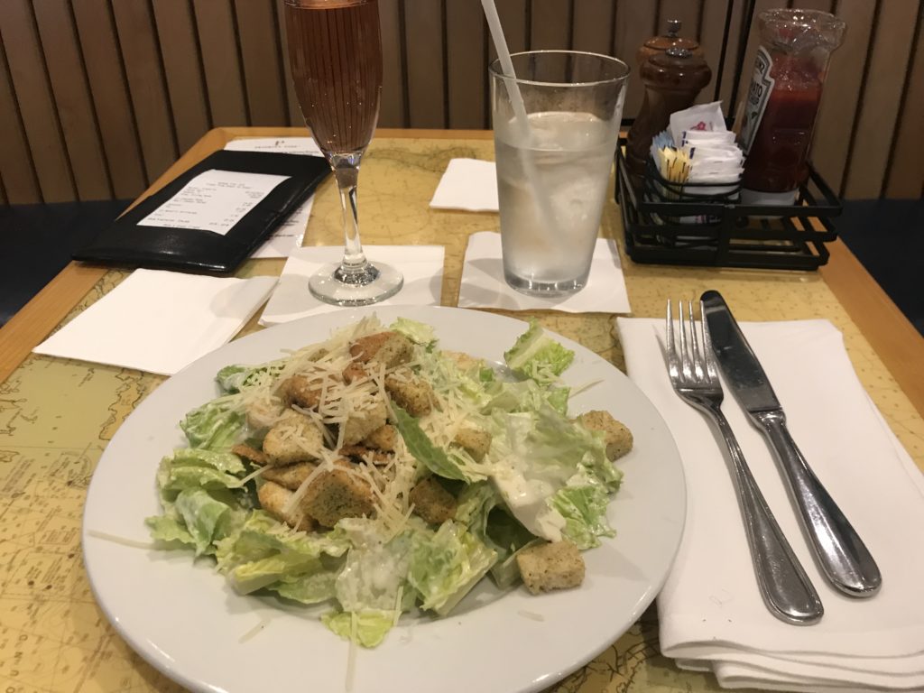 a plate of salad and two glasses of water