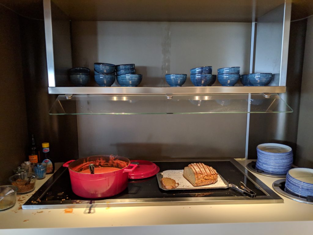 a kitchen with a pan of food on a stove